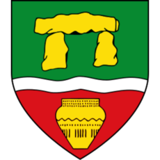 Stadtwappen von Werste in Bad Oeynhausen mit goldenem Megalithgrab auf grünem Grund, silbernem Wellenbalken und goldener Urne auf rotem Feld