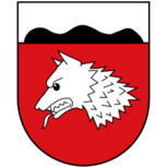 Stadtwappen von Wulferdingsen mit silbernem Wolfskopf auf rotem Grund und schwarzem Dreiberg im silbernen Schildhaupt